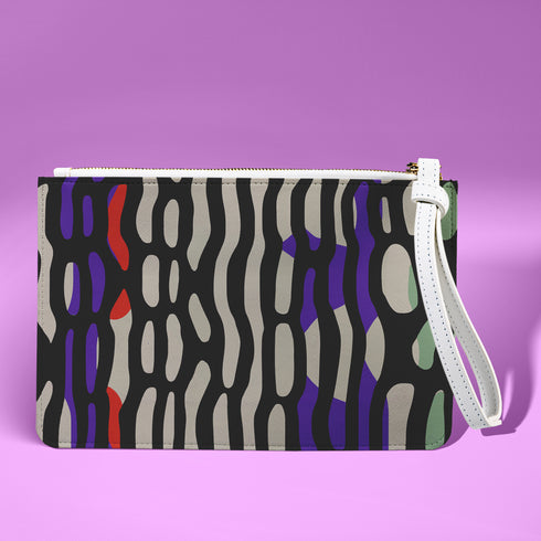 Rectangular wristlet clutch bag with psychedelic black, purple, red, and green pattern. White wrist strap and gold zipper visible